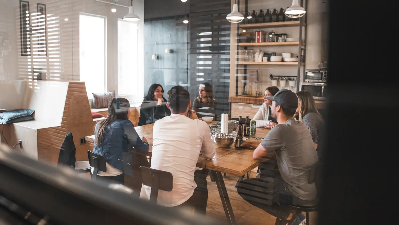 The team working together around a table in an open office
