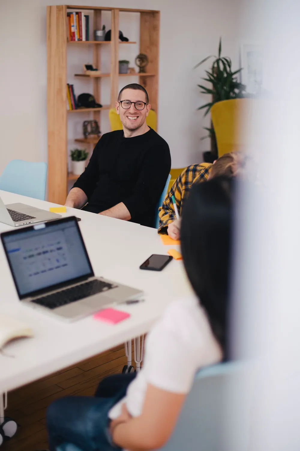 A smiling team member at his desk