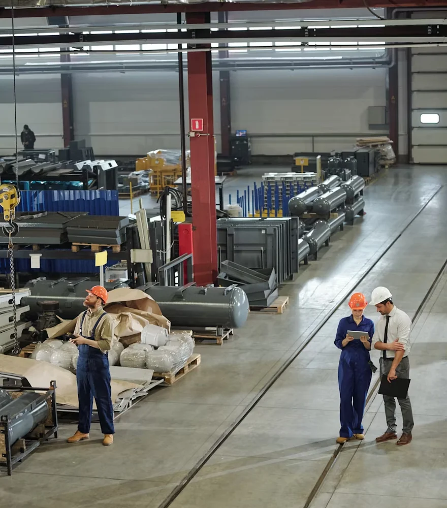Workers on the floor of an industrial manufacturing plant