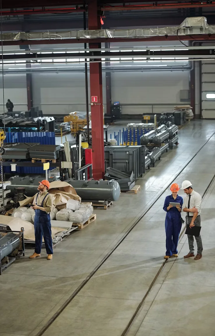 Workers on the floor of an industrial manufacturing plant